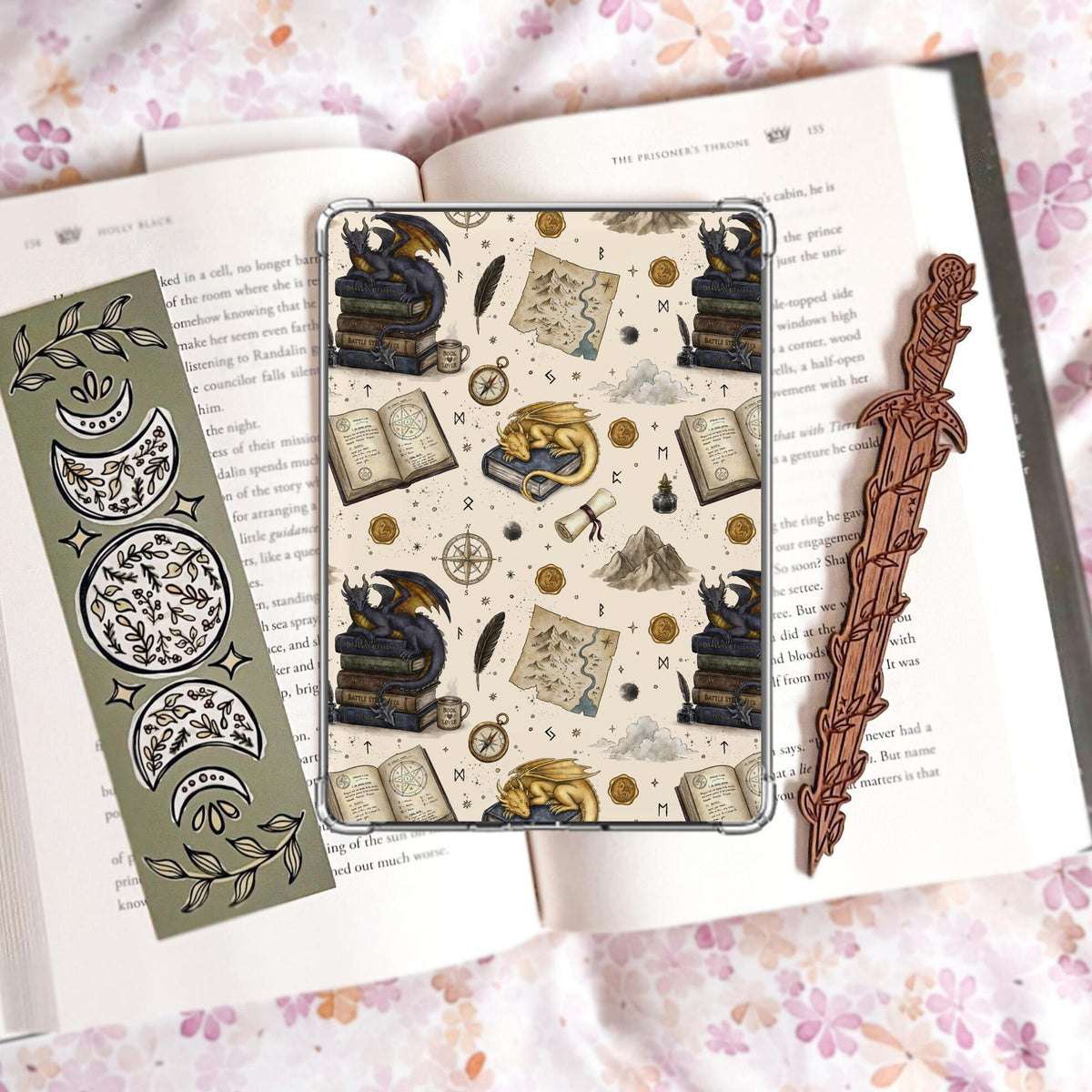 Cream Kindle insert pattern with a gold sleeping dragon and a dark dragon perched on stacked books, alongside a treasure map, compass, quill, ink well, and wax seals.