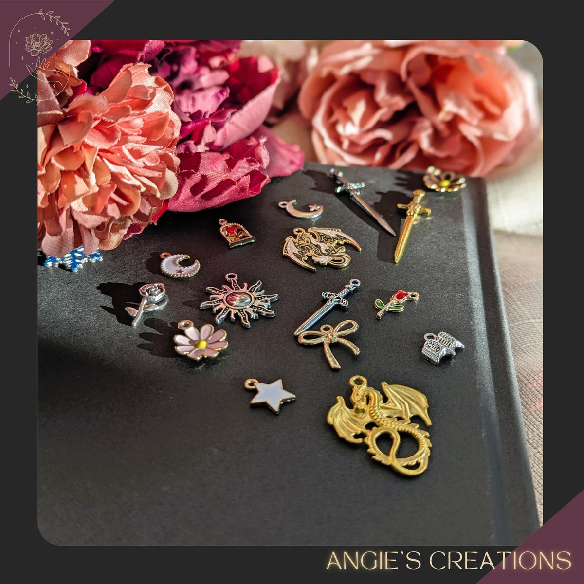 A handmade romantasy-themed Kindle charm chain featuring a detailed dragon charm, silver sword, crescent moon, flower charm, and tiny open book, attached to a silver lobster clasp. Perfect for fantasy readers and bookish accessory lovers.