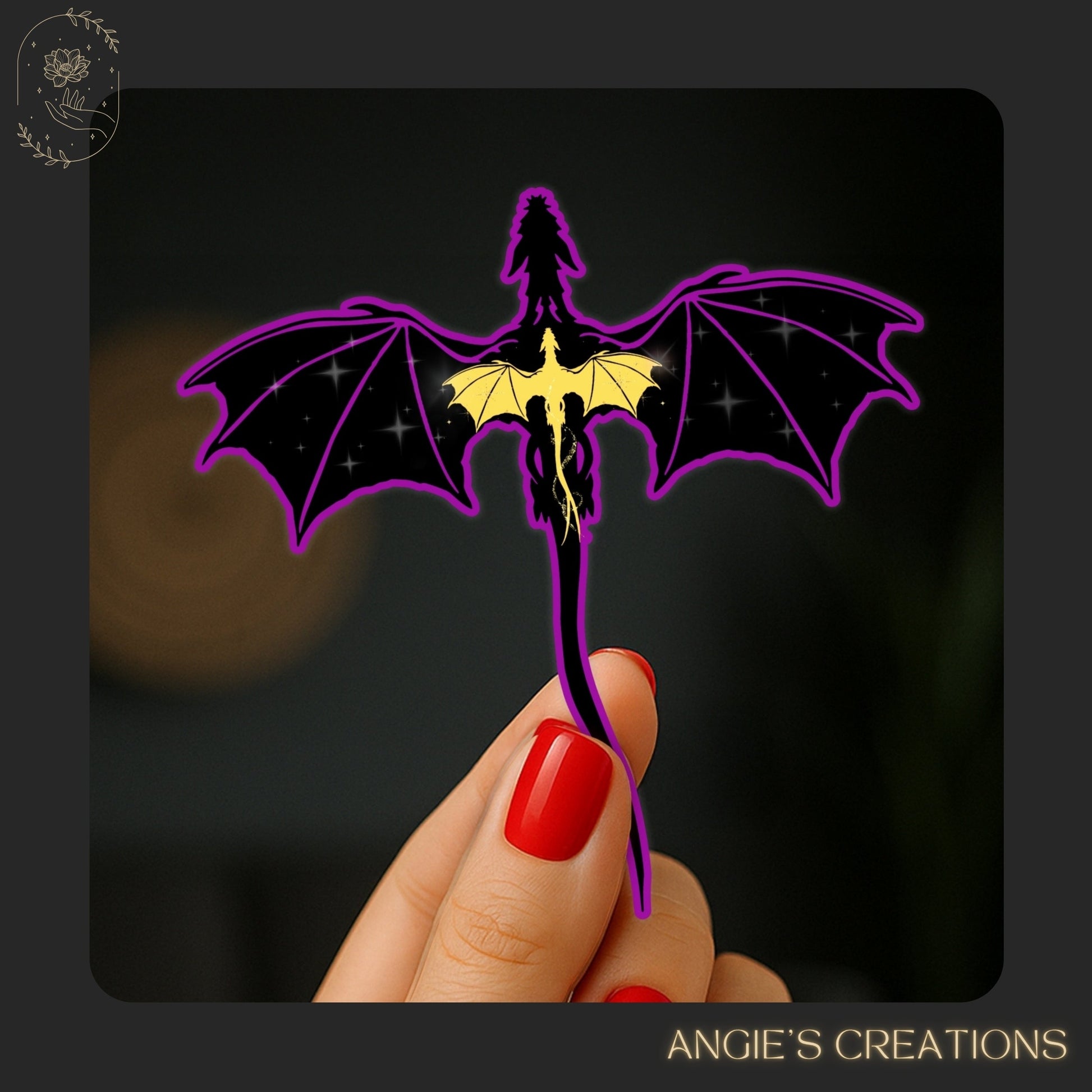 A hand holding a dragon-shaped cutout against a dark background.