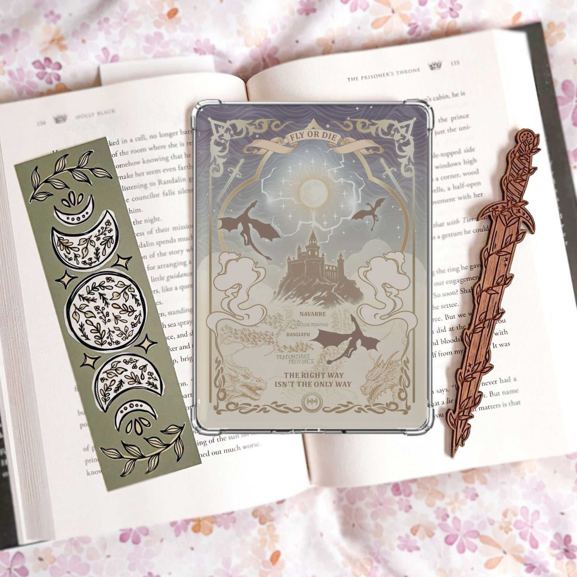 Handmade grey and gold Kindle insert with dragon silhouettes, moonlit castle, Basgiath and Navarre map text, reading "Fly or Die" and "The right way isn't the only way," displayed on an open book