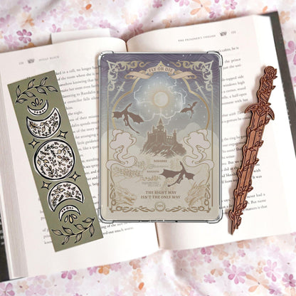 Handmade grey and gold Kindle insert with dragon silhouettes, moonlit castle, Basgiath and Navarre map text, reading "Fly or Die" and "The right way isn't the only way," displayed on an open book