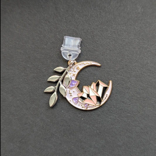 Angie's Creations hand-assembled USB-C dust plug featuring a gold crescent moon enamel charm with purple and pink geometric crystal detail and a silver botanical leaf branch accent charm. Celestial romantasy inspired phone or Kindle accessory handcrafted in Ottawa Canada.