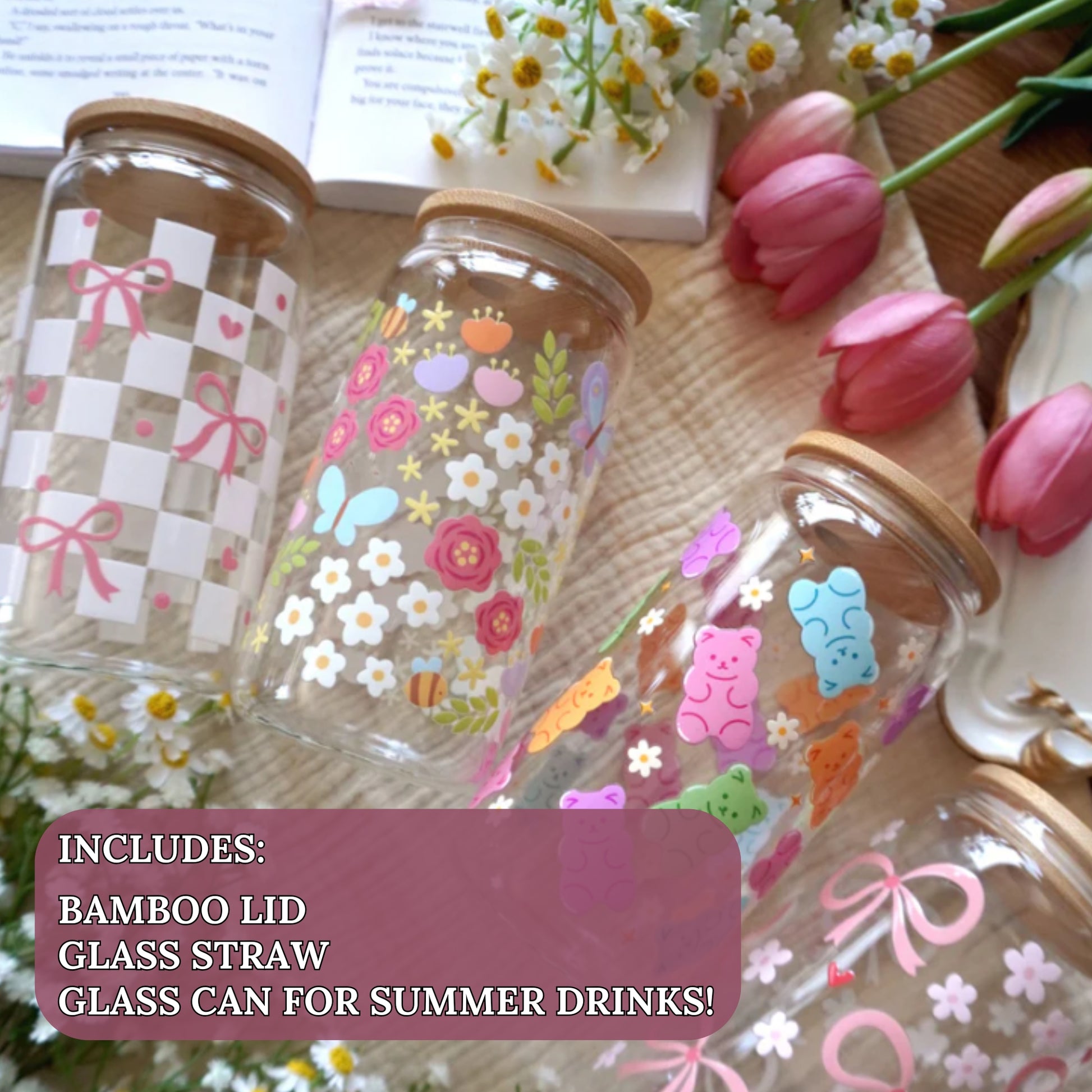 Three 16oz Libbey can glass cups with bamboo lids styled with pink tulips and daisies featuring coquette checkerboard bows, happy spring garden butterflies and florals, and rainbow gummy bear wrap designs. Each cup includes bamboo lid and glass straw, designed and finished by hand in Ottawa Canada by Angie's Creations.