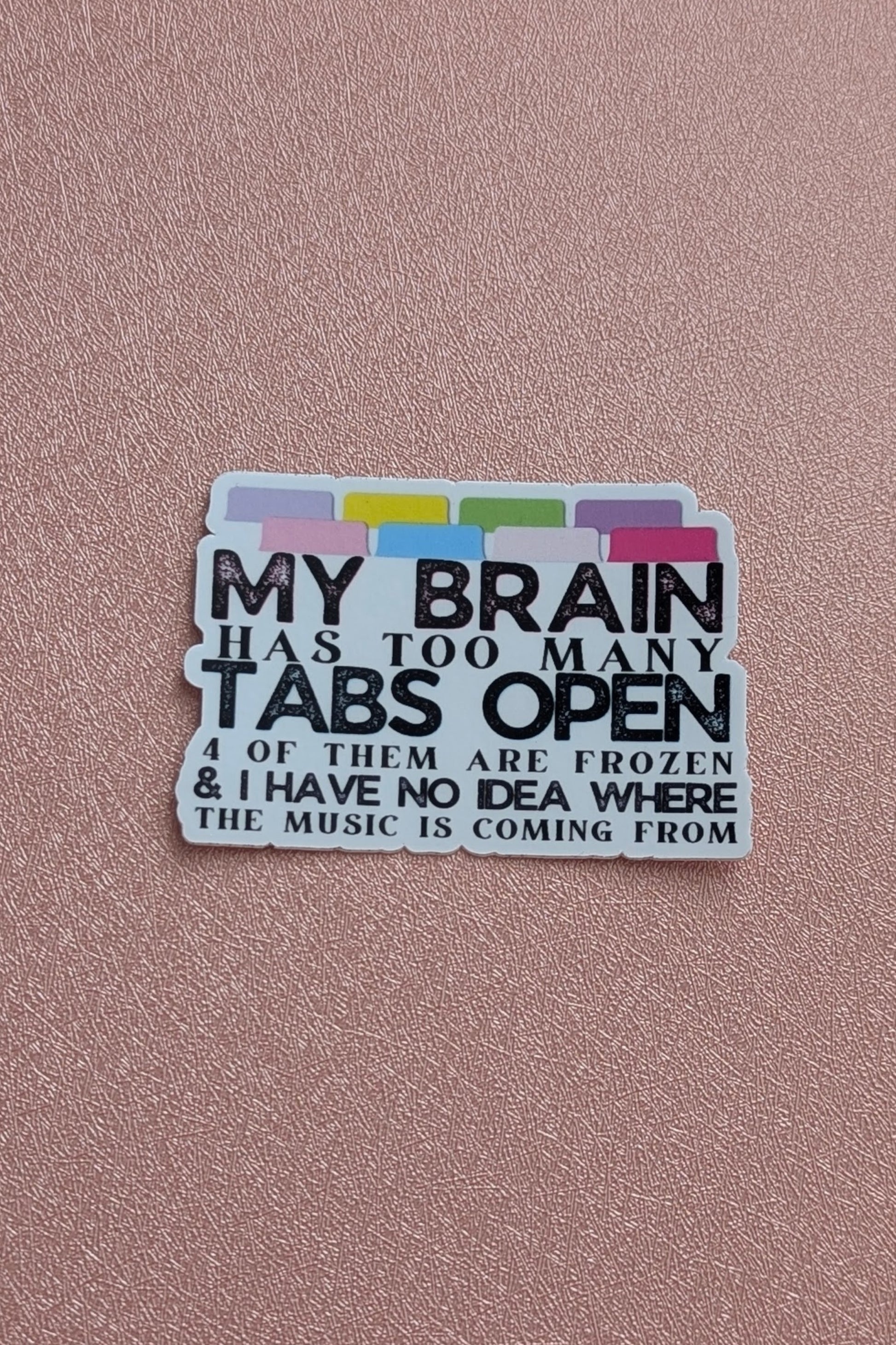 Sticker with text about too many tabs open on a pink background