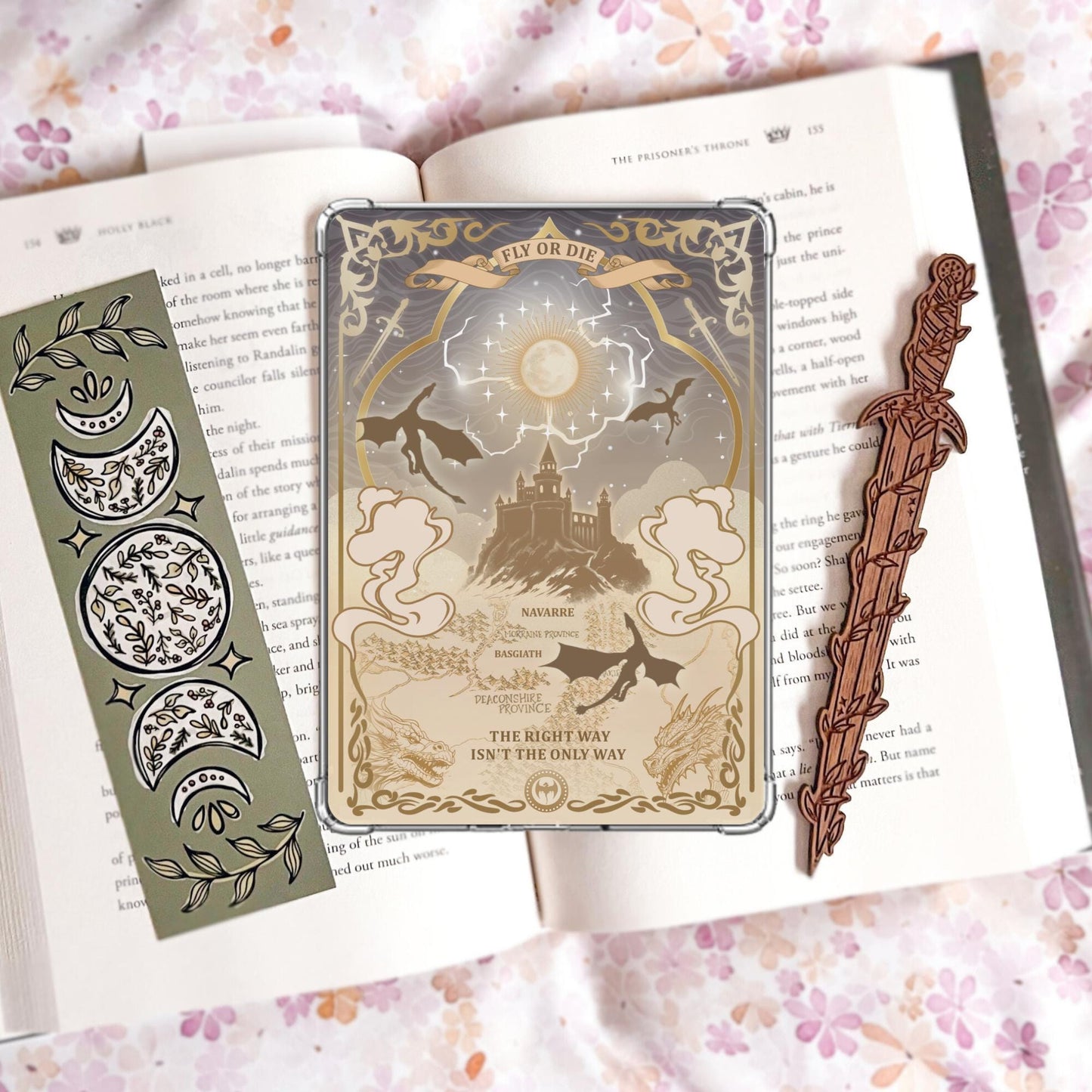 Handmade grey and gold Kindle insert with dragon silhouettes, moonlit castle, Basgiath and Navarre map text, reading "Fly or Die" and "The right way isn't the only way," displayed on an open book