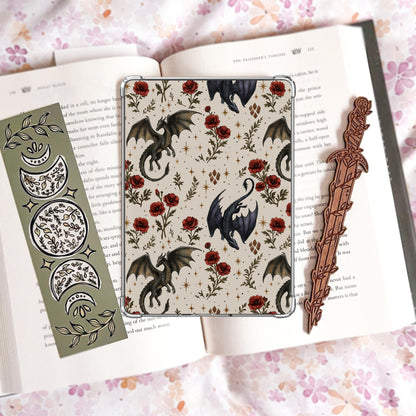 Handmade grey Kindle insert featuring hand drawn dark dragons surrounded by red poppy flowers and stars in a repeating pattern