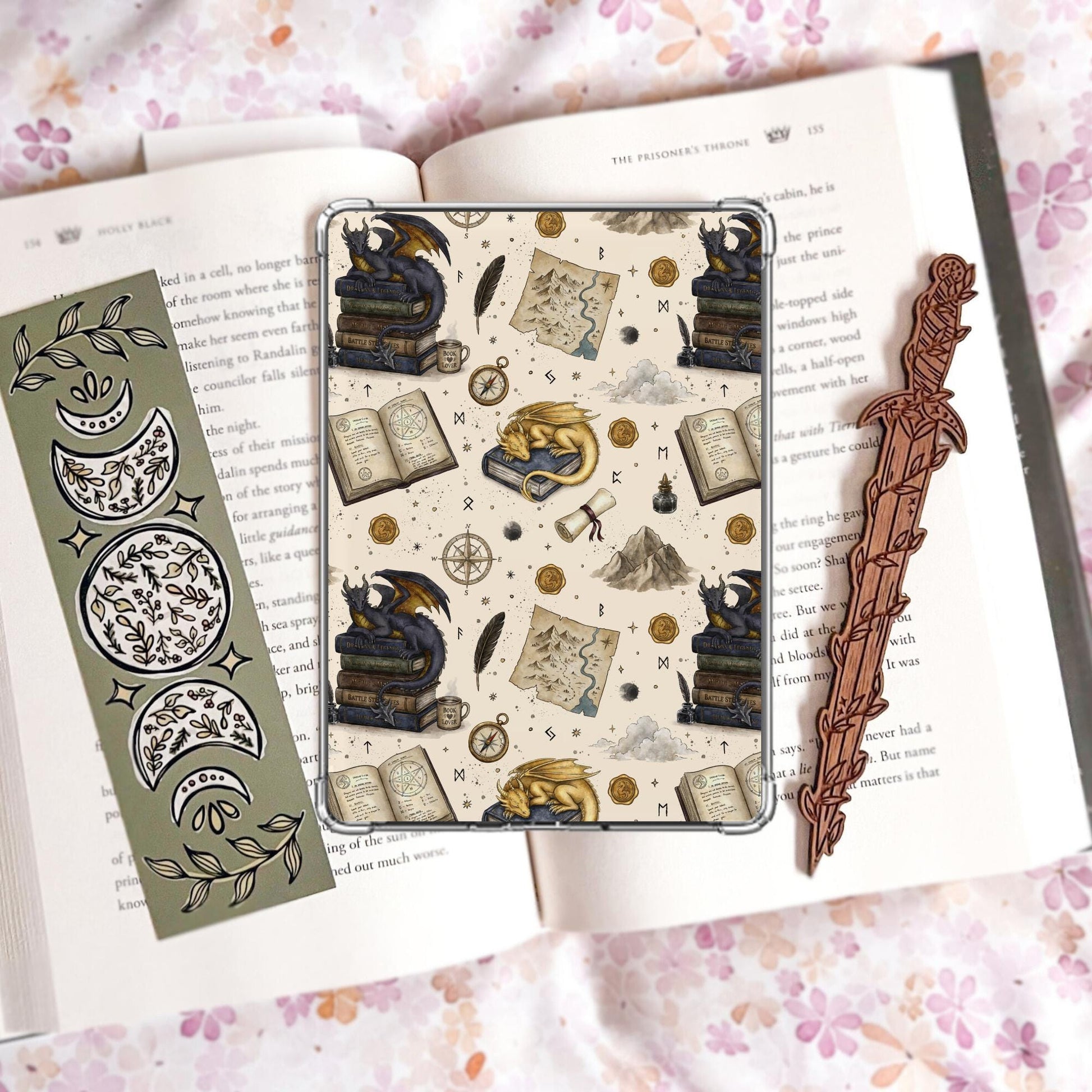 Cream Kindle insert pattern with a gold sleeping dragon and a dark dragon perched on stacked books, alongside a treasure map, compass, quill, ink well, and wax seals.