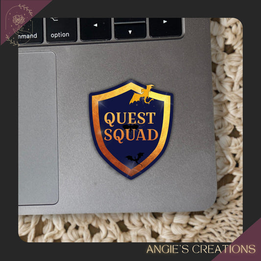 a laptop with a sticker on it that says "QUEST SQUAD".