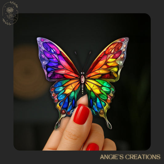 A hand holding a colorful butterfly with vibrant, multicolored wings against a dark background.