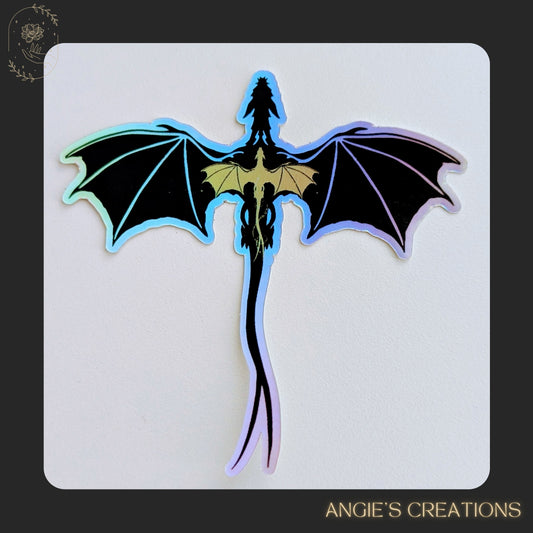 A powerful duo in one design — this holographic vinyl sticker captures Violet Sorrengail’s legendary dual bond with Tairn and Andarna from Fourth Wing. Featuring the formidable black dragon alongside the radiant golden feathertail, it’s a must-have for dragon fans and romantasy readers.