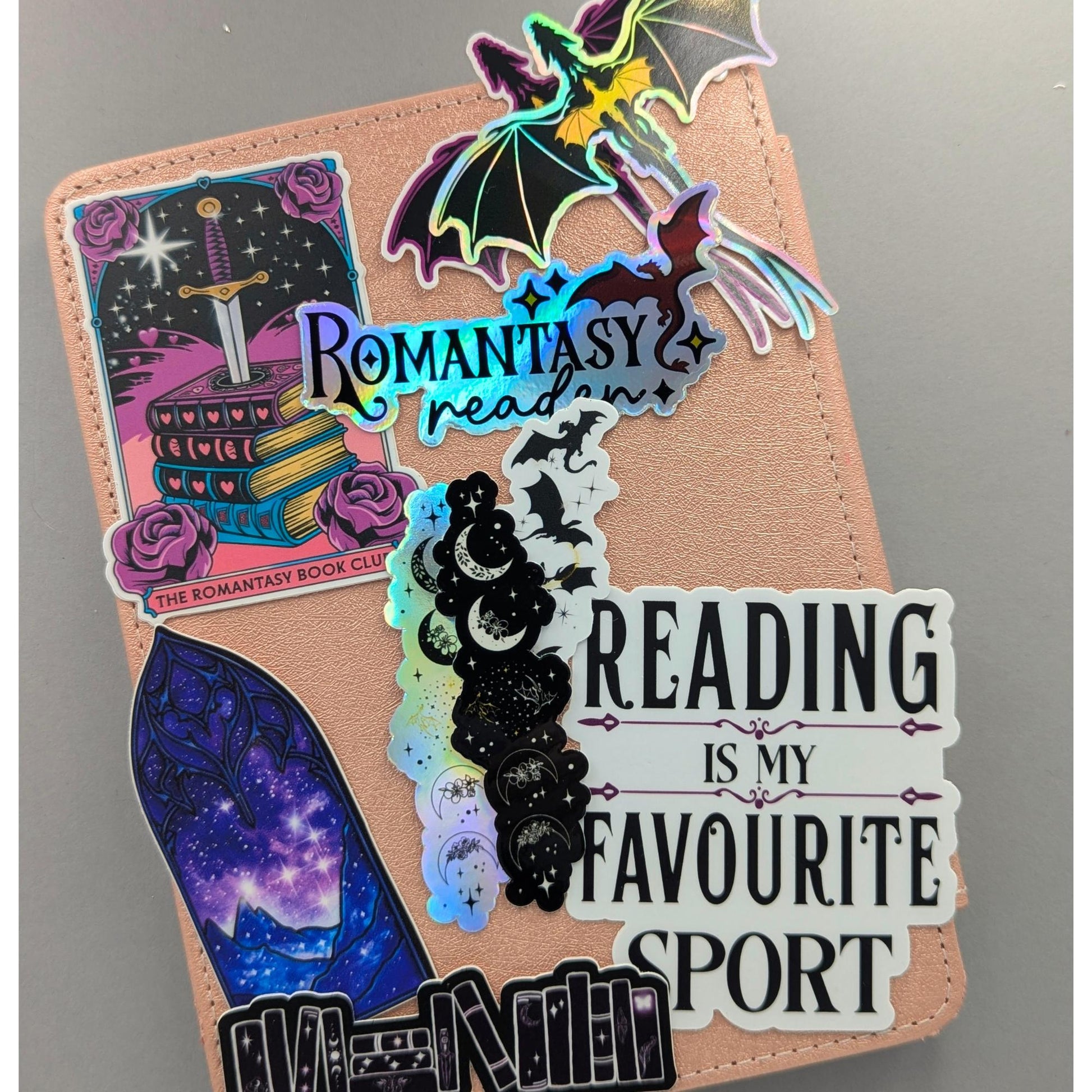 You didn't choose the romantasy life. It chose you. One chapter became one series became a TBR with its own postal code. This holographic sticker is for the girlie with a dragon on her Kindle, a book boyfriend in her heart, and zero apologies about either.