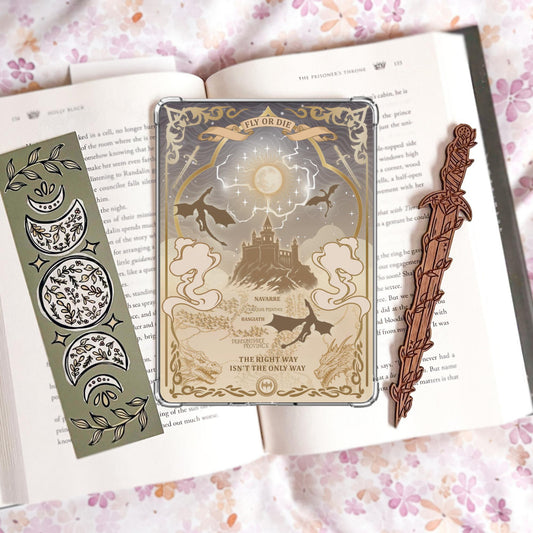 Handmade grey and gold Kindle insert with dragon silhouettes, moonlit castle, Basgiath and Navarre map text, reading "Fly or Die" and "The right way isn't the only way," displayed on an open book
